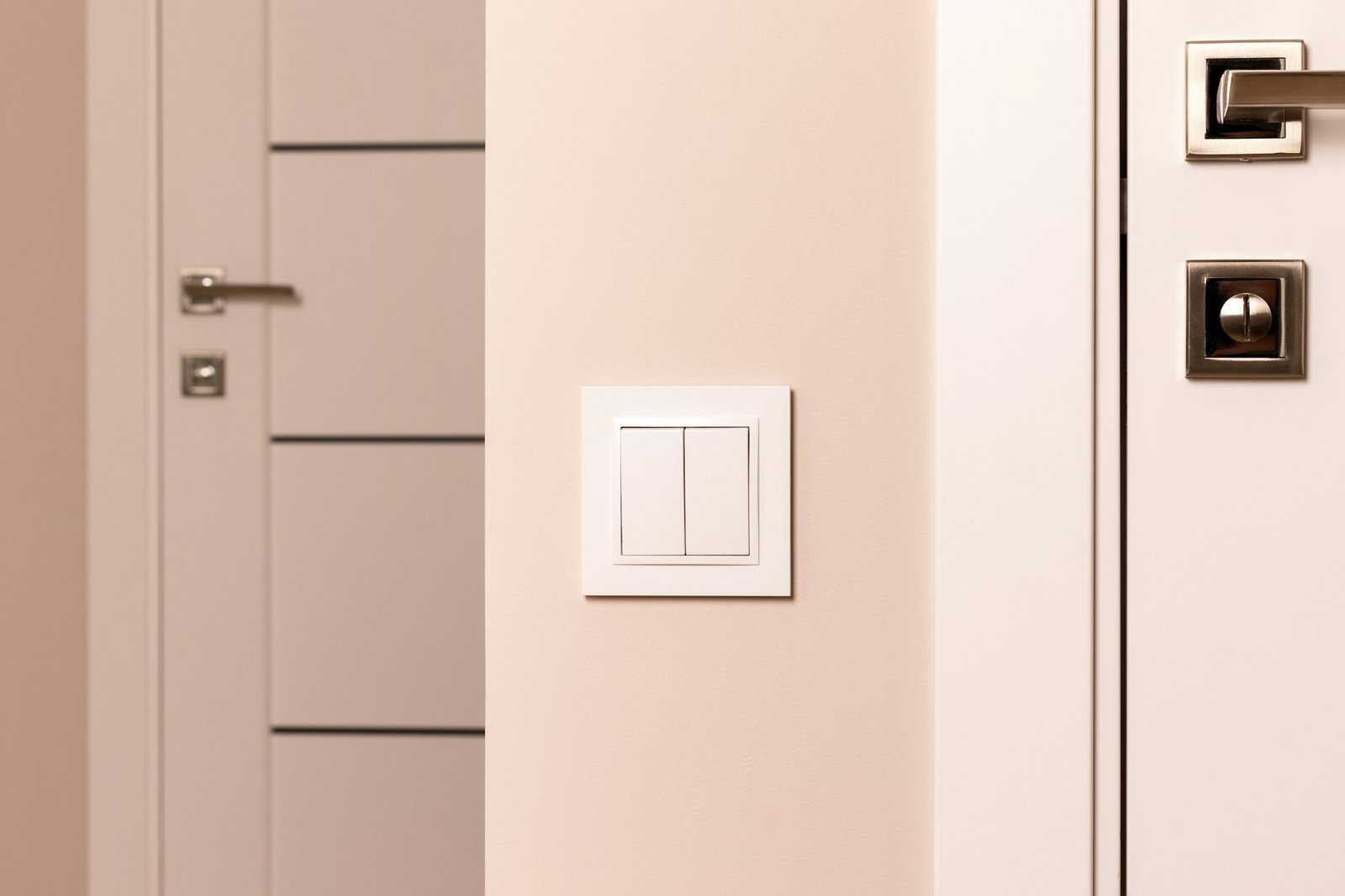 White electrical switch on beige wall